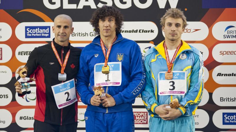 Three men on a podium