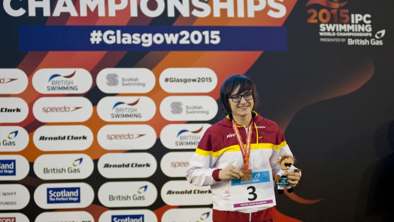 Maria Delgado Nadal of Spain on the podium after the women's 100m backstroke S12 at the 2015 IPC Swimming World Championships in Glasgow.