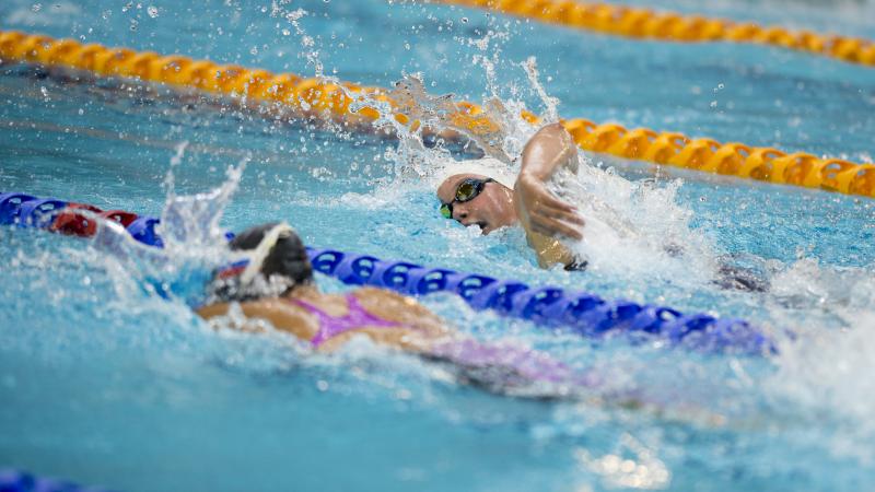 Two swimmers racing in a pool