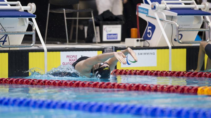 Swimmer makes a backstroke start.