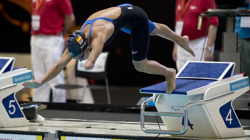 A swimmer launches off of the starting blocks