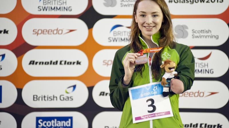 A para-swimmer celebrates winning a medal