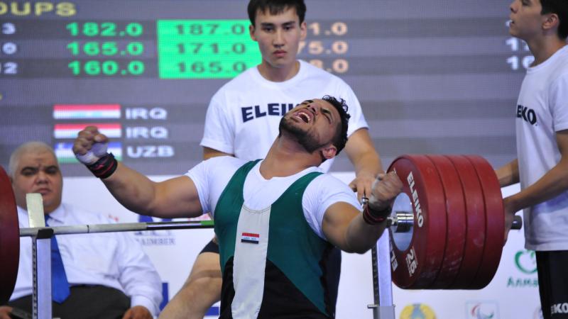 Man sitting on bench, celebrating