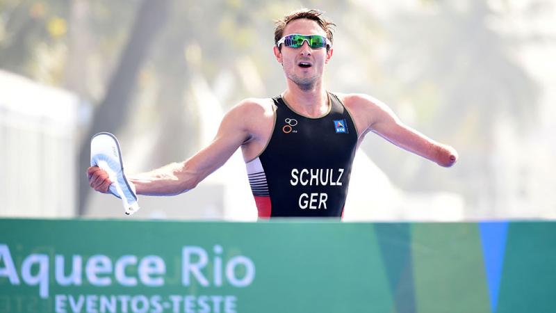 Man with an arm amputation crossing a finish line