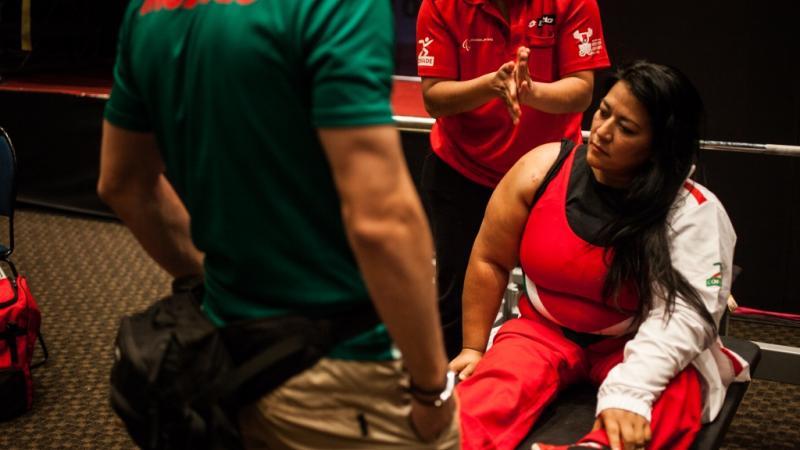 Woman sitting on a bench, preparing for her competition