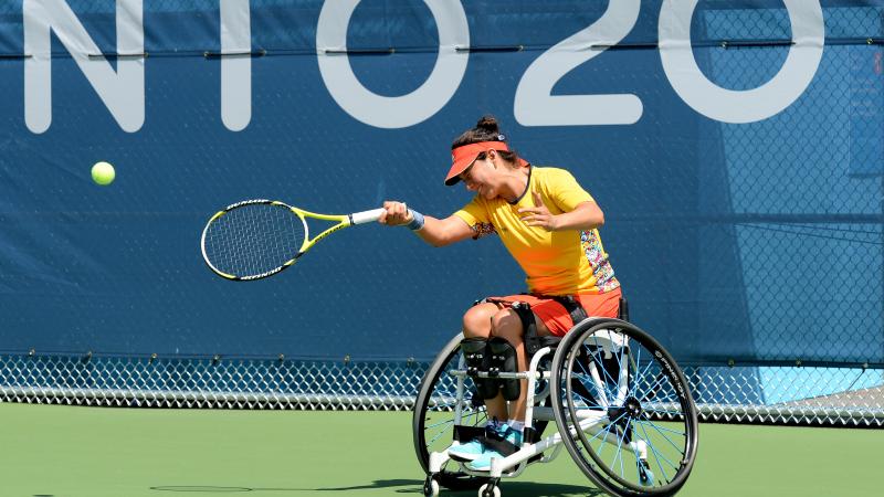 Wheelchair tennis player hitting a ball