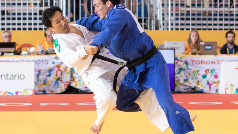 Luis Perez Diaz of Puerto Rico, fighting against Robert Kim of USA in the men's -66kg judo at the Toronto 2015 Parapan American Games.