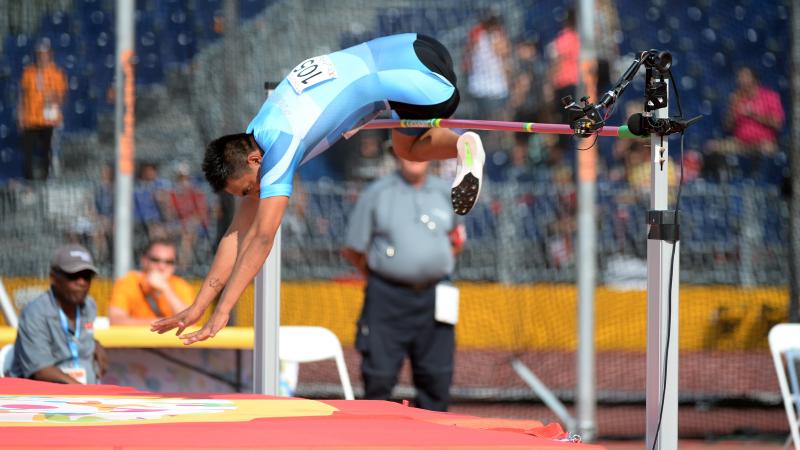 Man during a high jump in a stadium