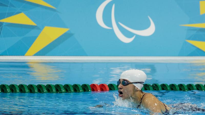 Action shot of Ilena Rodriguez swimming. Her head is just above water