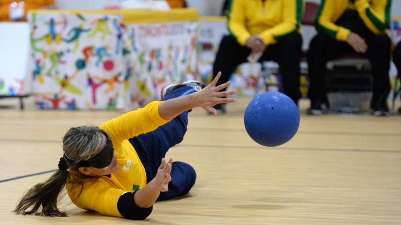 Blindfolded woman catching the ball during a goalball match
