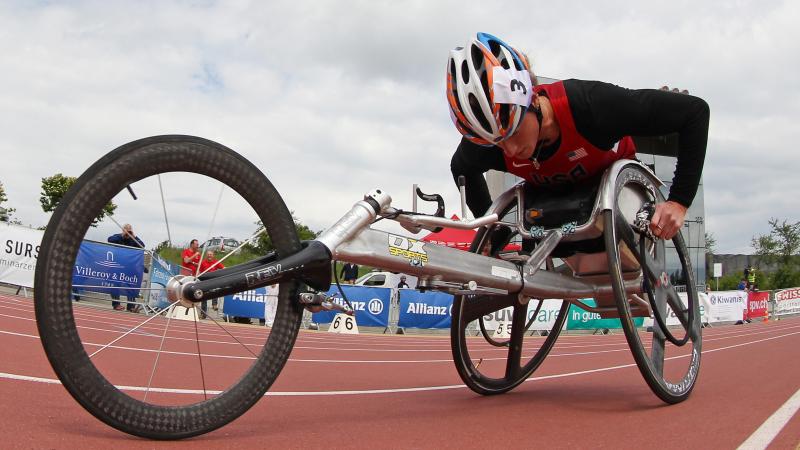 Woman in a racing wheelchair competing