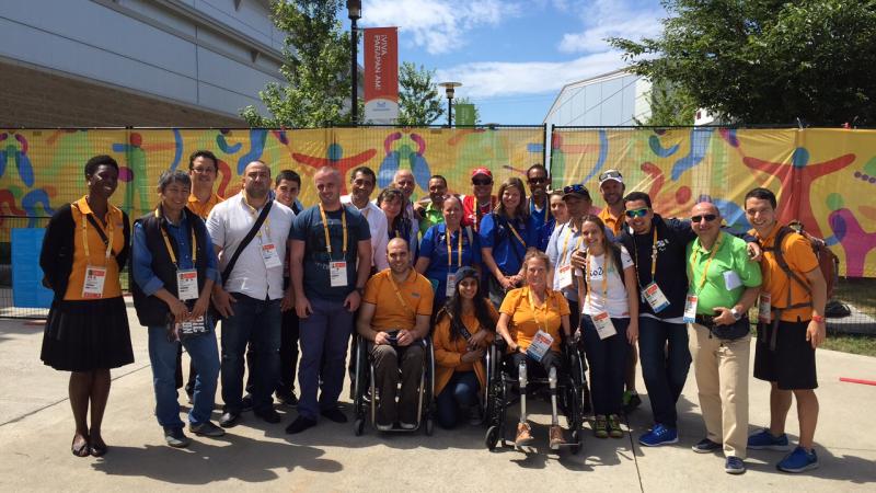 Group photo of people standing and in wheelchairs