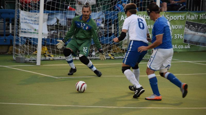 Blindfolded football player targeting the goal