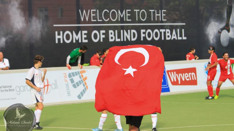 A group of blind football players celebrate a win
