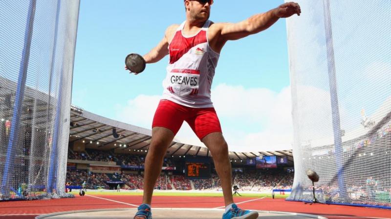 Dan Greaves of England competes in the Men's F42/44 Discus final at Hampden Park Stadium at the Glasgow 2014 Commonwealth Games.