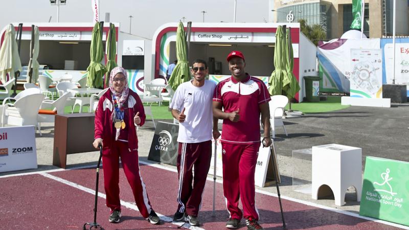 Three athletes pose for a photo