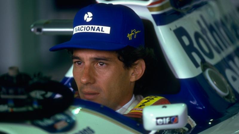 Face of a man sitting in a Formula 1 car.