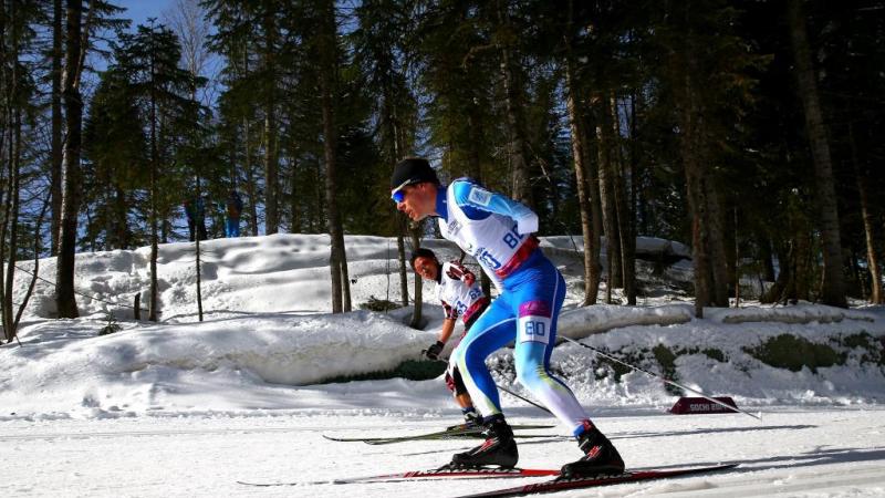 Ilkka Tuomisto of Finland and Dexin Zhou of China compete in the Men's Cross Country 10km Free Standing at the Sochi 2014 Paralympic Winter Games.