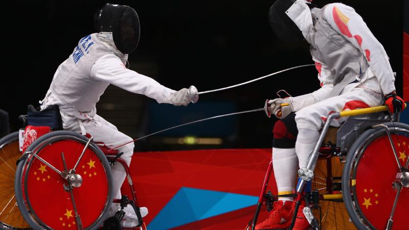 Ruyi Ye (L) of China on his way to winning gold against Yijun Chen (R) of China during the men's individual foil category A final of the wheelchair fencing at the London 2012 Paralympic Games.