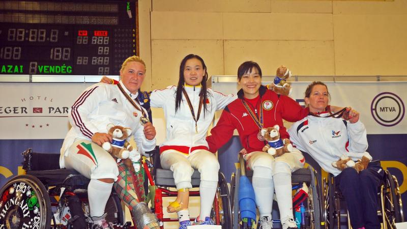 Four athletes at the medal ceremony.