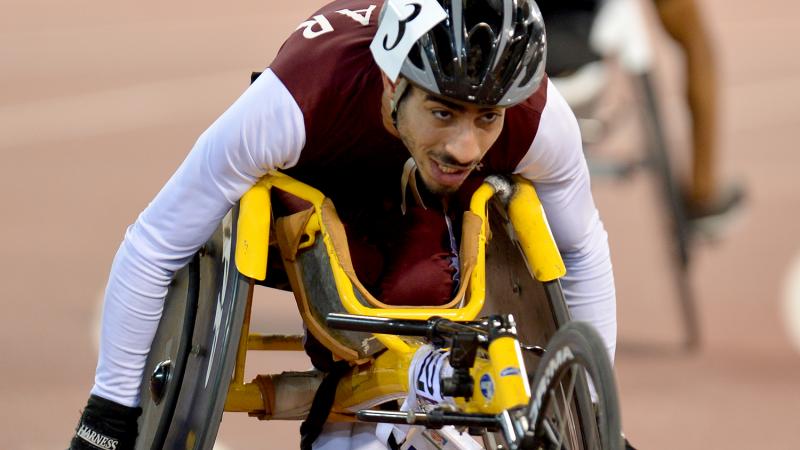 Man in racing wheelchair on track