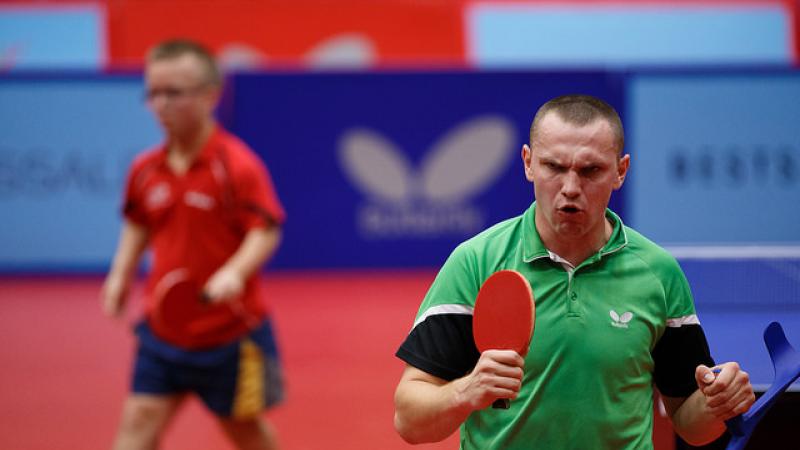 Man with table tennis racket celebrates