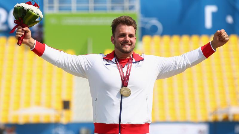 Great Britain's Aled Davies poses with his gold medal at the medal ceremony for the men's shot put F42 final at the 2015 IPC Athletics World Championships in Doha, Qatar. 