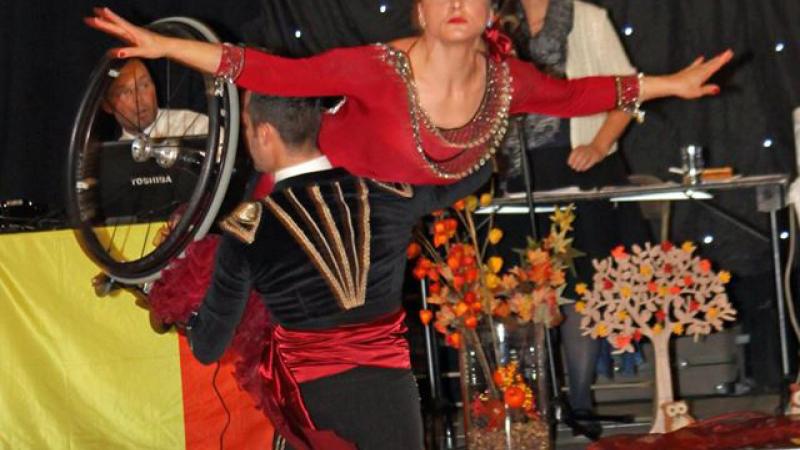 A wheelchair dancer is held aloft during a dance 
