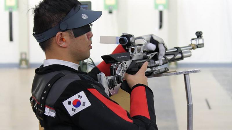 A shooter calms himself during a match