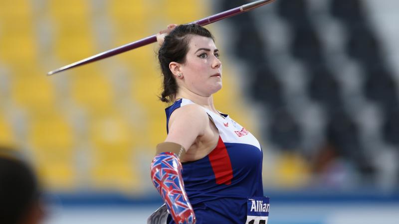 Woman with arm prosthesis throwing a javelin