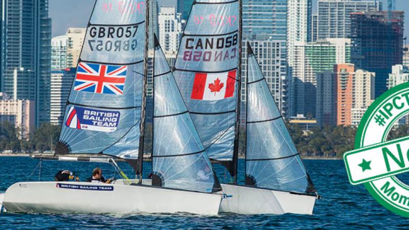 Two sailing boats in the water with skyline in the background