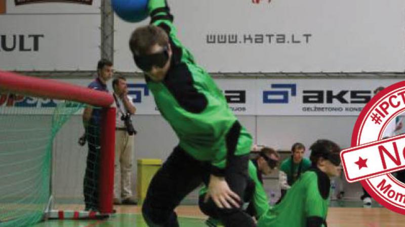 Goalball scene with one player throwing the ball