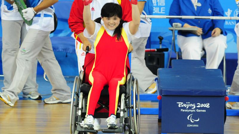 A Chinese powerlifter celebrates winning gold in powerlifting at her home Paralympic Games.