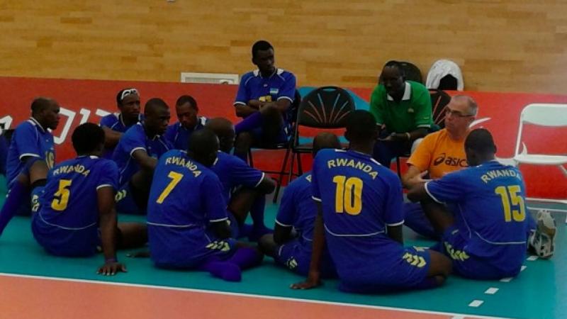 Rwanda sitting volleyball - coach Karremann Group of people listening to one man