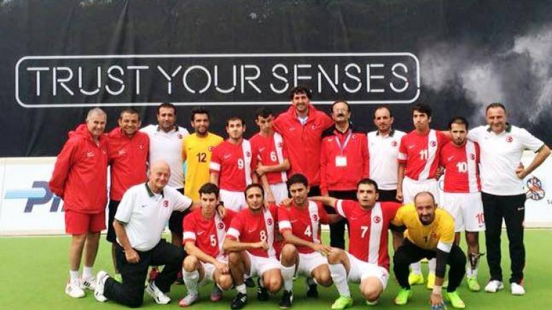 Group picture of men wearing red shirts