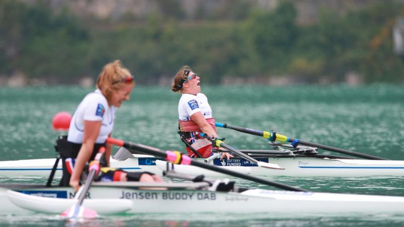 Woman in rowing boat celebrating