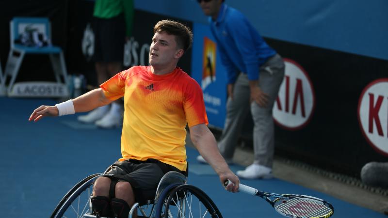 Man in wheelchair playing tennis