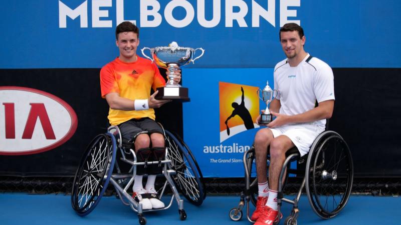 Wheelchair tennis player lifts the Australian Open trophy