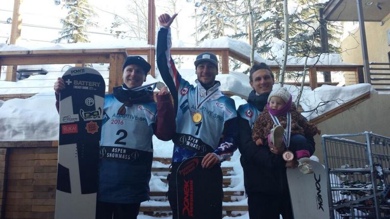 Three adaptive snowboarders celebrate their podium finishes at the 2016 IPC Snowboard World Cup in Aspen, USA