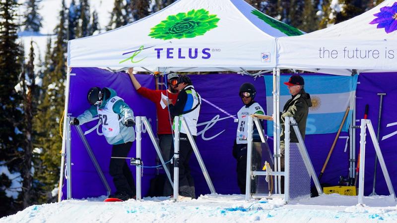 Snowboarders in the start boxes