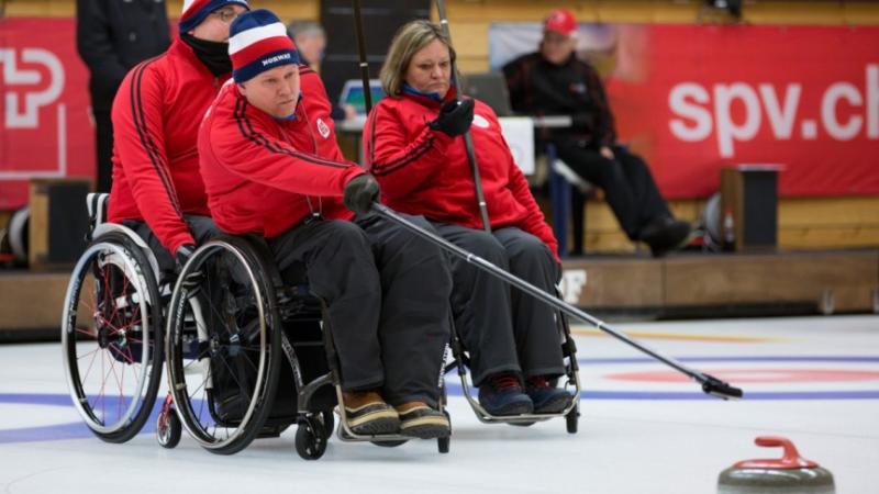 Wheelchair curlers in action