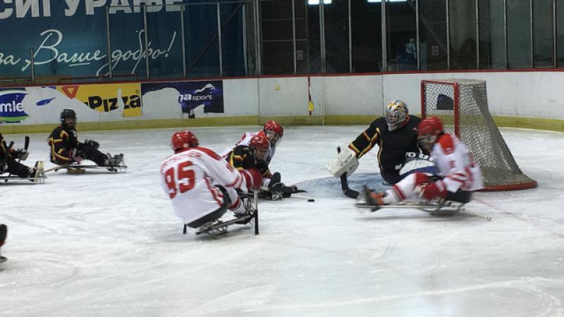 A sledge hockey field of play with players