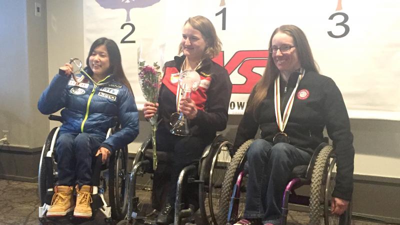 A sit-skier celebrates winning the overall super-G globe in Aspen, USA.