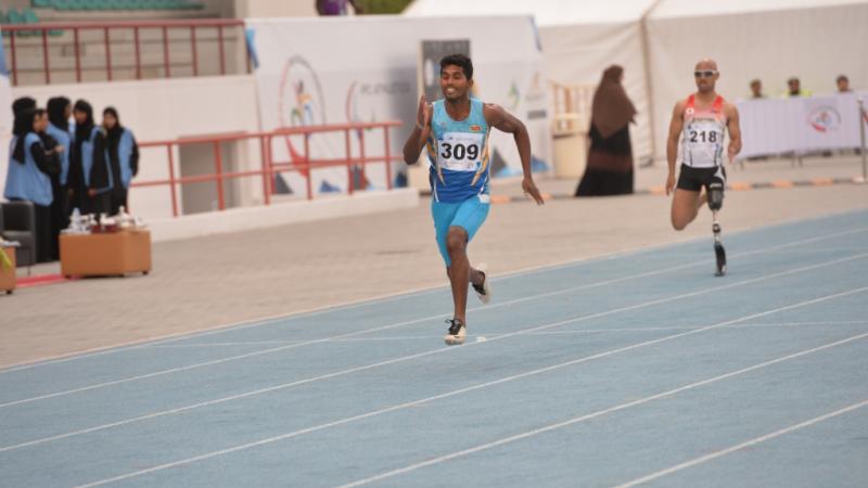 Man running on a blue track