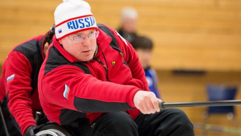 Andrey Smirnov - Russia - 2016 World Wheelchair Curling Championships Man in wheelchair doing wheelchair curling