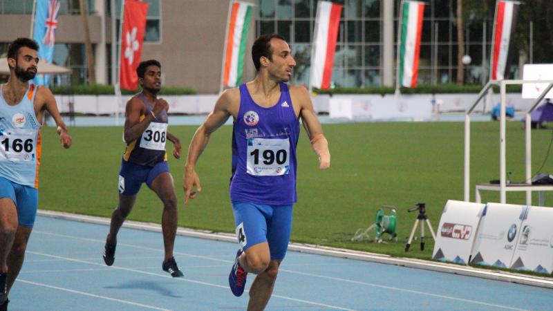 A man crossses the finish line in celebration.