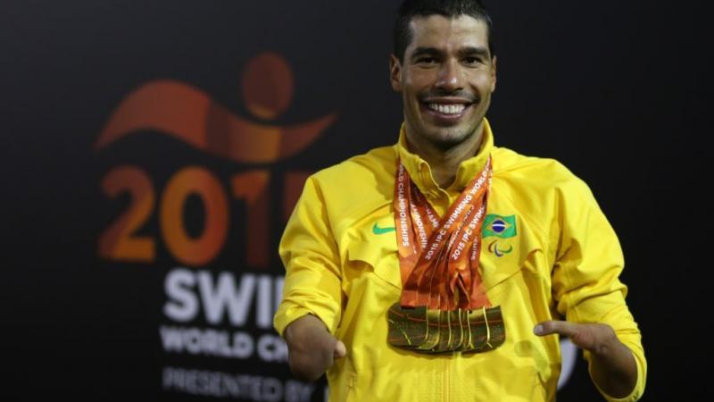 Daniel Dias of Brazil poses with his seven gold medal he won at the IPC Swimming World Championships in Glasgow, Great Britain.
