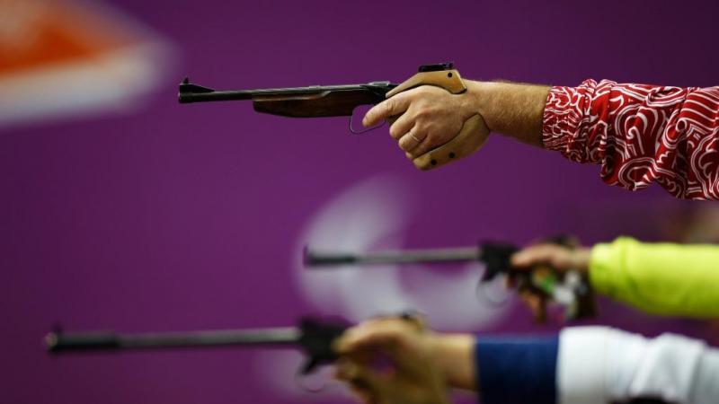 Competitors raise their pistols during the Mixed P4-50m Pistol-SH1 competition at the London 2012 Paralympic Games 