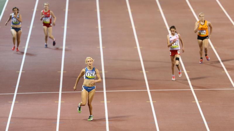 A para-athlete sprints towards the line