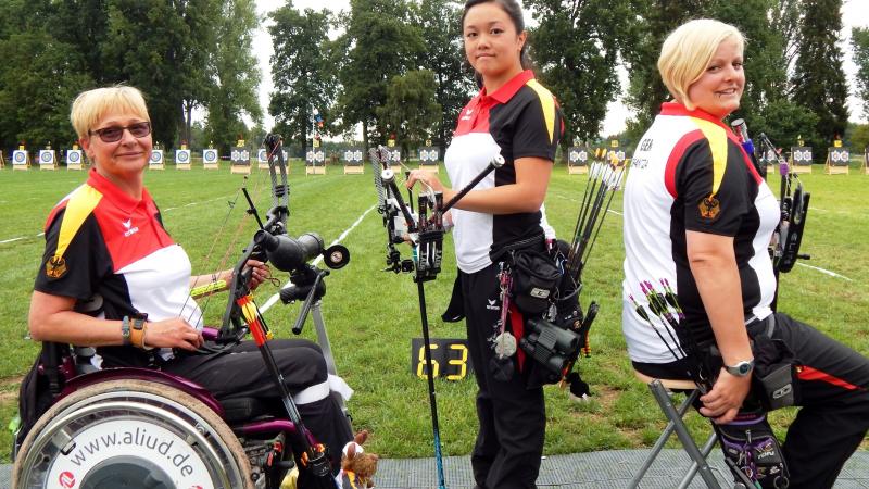 Three female archers posing